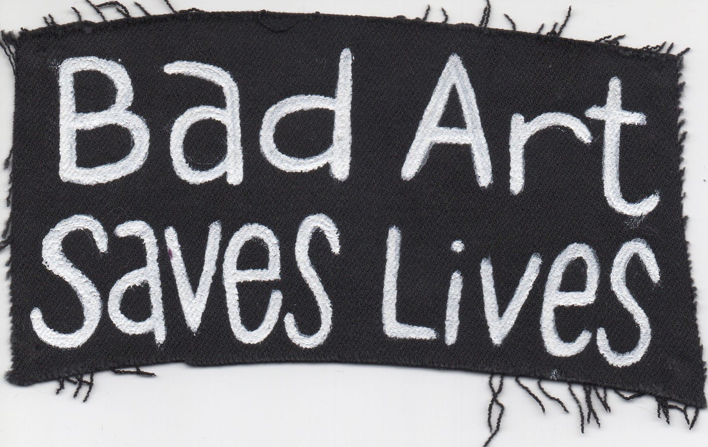 Painted “Bad Art Saves Lives” Patch on fabric from a pair of jeans.