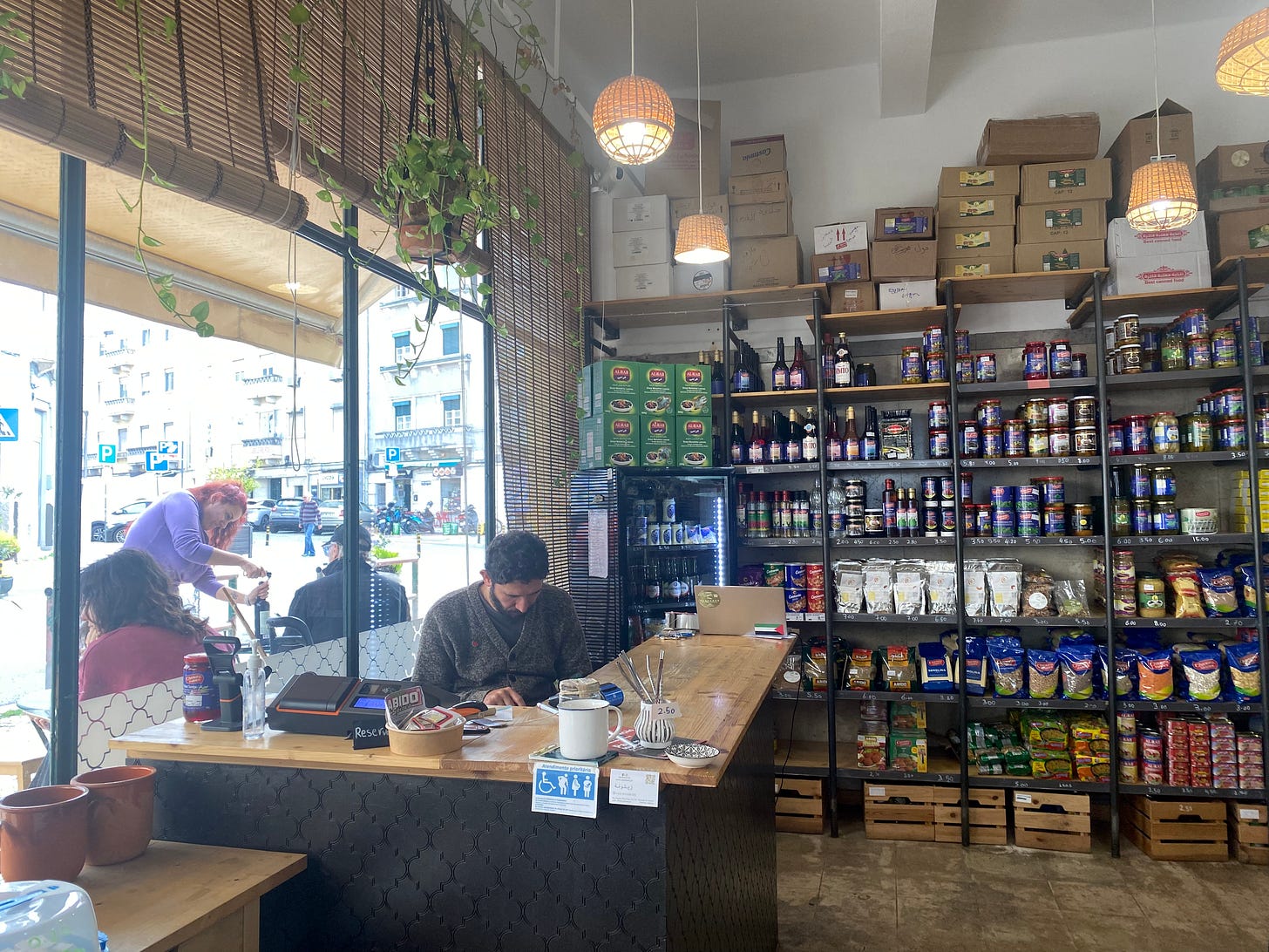 Man sat at counter in a Palestinian food shop