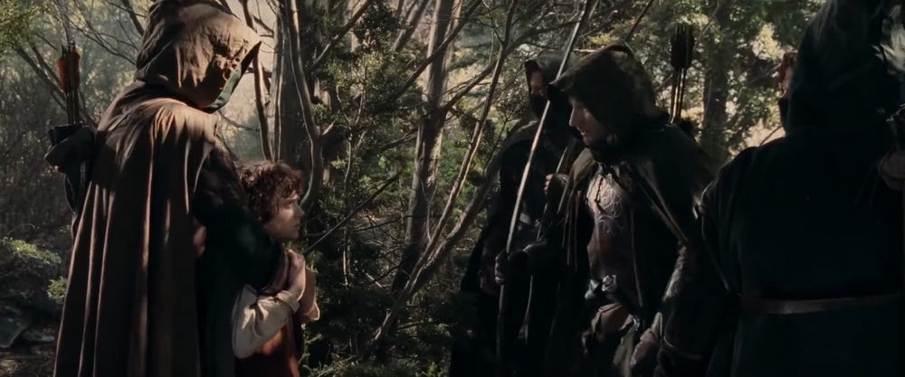 Faramir meets Frodo, who is restrained by Gondorian Rangers