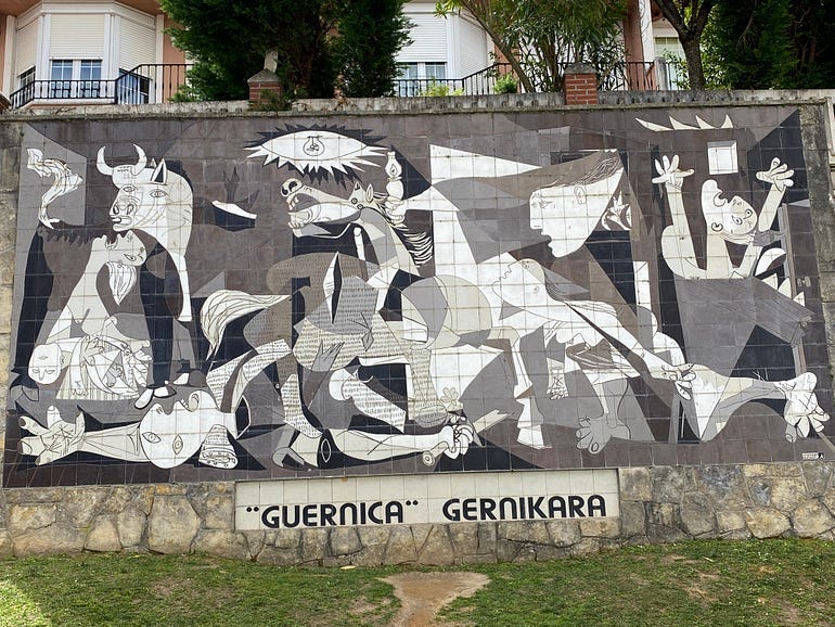 A black and white mural created by Picasso entitled Guernica, depicting the brutal bombing of the Spanish Civil War in 1937.