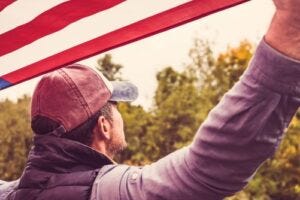 dude in a red cap with U.S. flag