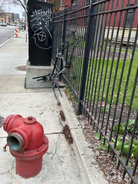 26 March 2024: It looks harmless enough, but this fire hydrant is just waiting to shatter my bones. A helpless bike without wheels looks on.