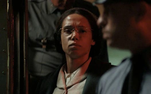 This image shows Rosa Parks (played by Vinette Robinson) exiting a Montgomery, Alabama bus on 1 December 1955 after being arrested for refusing to move to the back. Two Montgomery police officers stand behind and in front of Parks. This image shows Rosa Parks (played by Vinette Robinson) exiting a Montgomery, Alabama bus on 1 December 1955 after being arrested for refusing to move to the back. Two Montgomery police officers stand behind and in front of Parks.
