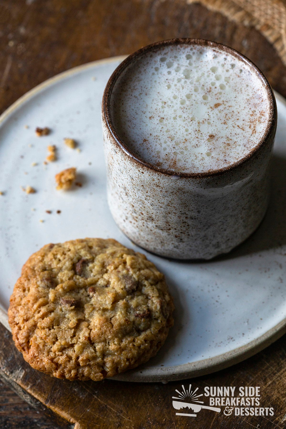 A mug of moon milk with a cookie.