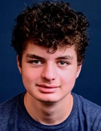 A picture of a teen's face against a blue background.
