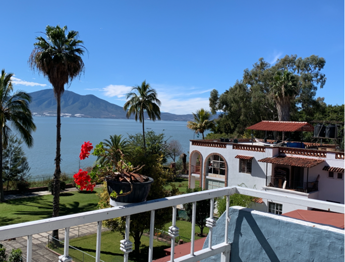 A balcony and garden with an ocean view