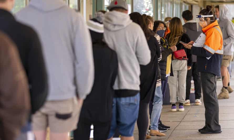 People queue outside a Covid vaccination hub in Melbourne