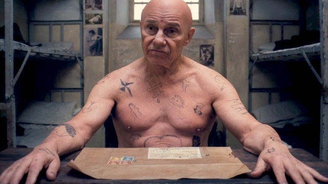 In The Grand Budapest Hotel, Ludwig's (Harvey Keitel's) "MAV" tattoo on his  left arm is the abbreviation of the French saying "mort aux vaches", which  translates to "death to cows". : r/MovieDetails