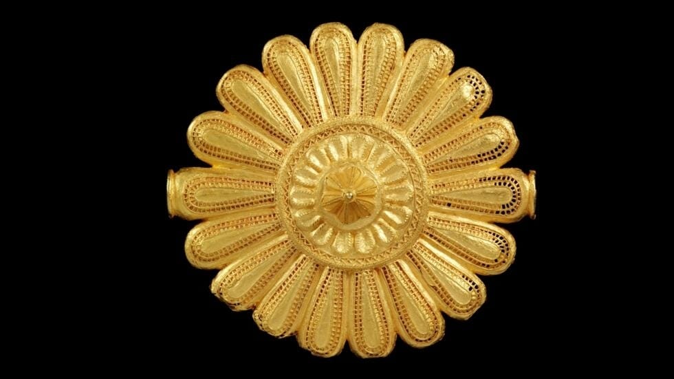 A cast gold badge, once worn by the Asante king's "soul washer", originating from Ghana and now in the collection of the Victoria and Albert Museum in London.