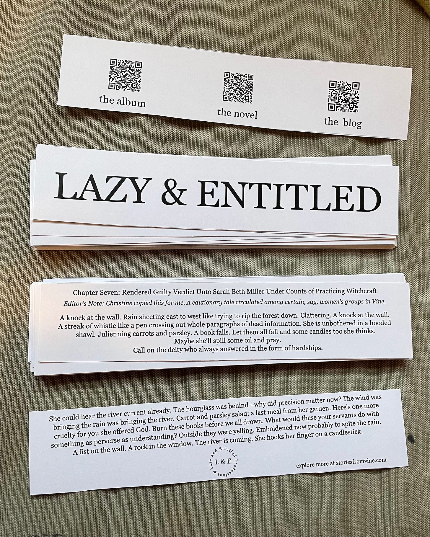 two bookmarks: one that reads 'LAZY & ENTITLED' on the front with QR codes for our album, novel, and blog on the back; one bookmark that has the full text of Chapter Seven from Vine on the front and back