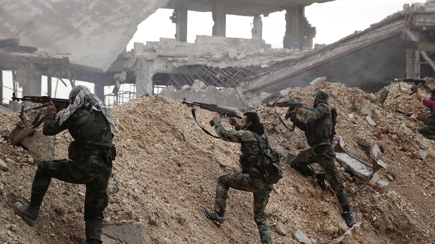 In this Dec. 5, 2016 file photo, Syrian army soldiers fire their weapons during a battle with rebel fighters at the Ramouseh front line, east of Aleppo, Syria. - Sputnik International, 1920, 07.12.2024