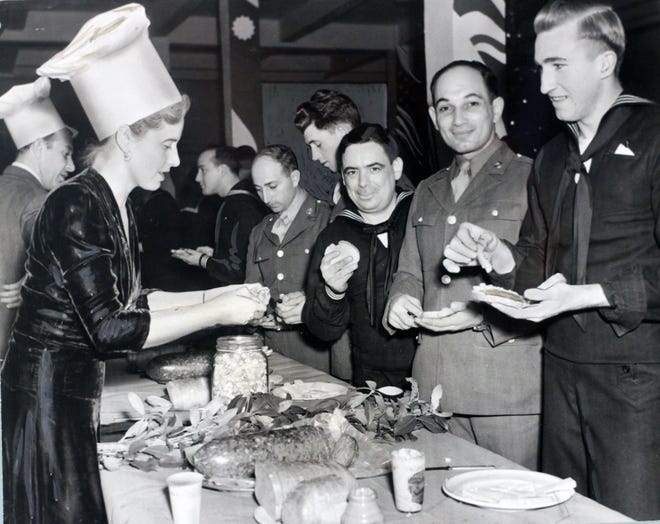 In December 1942, servicemen enjoyed themselves at the Gallery Canteen in Providence. Mrs. Gordon Washburn, wife of the director of the Rhode Island School of Design Museum, was among the volunteers serving refreshments.