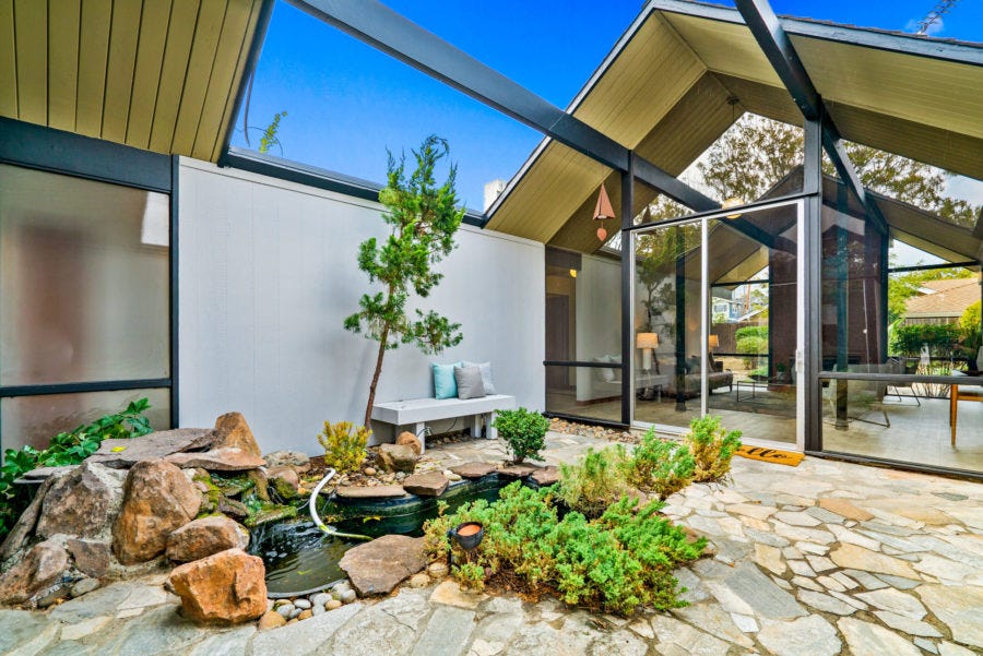 interior courtyard of Eichler home with open roof and plants in the courtyard