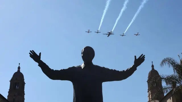 Aircraft perform a fly-by over a statue of former South African president Nelson Mandela