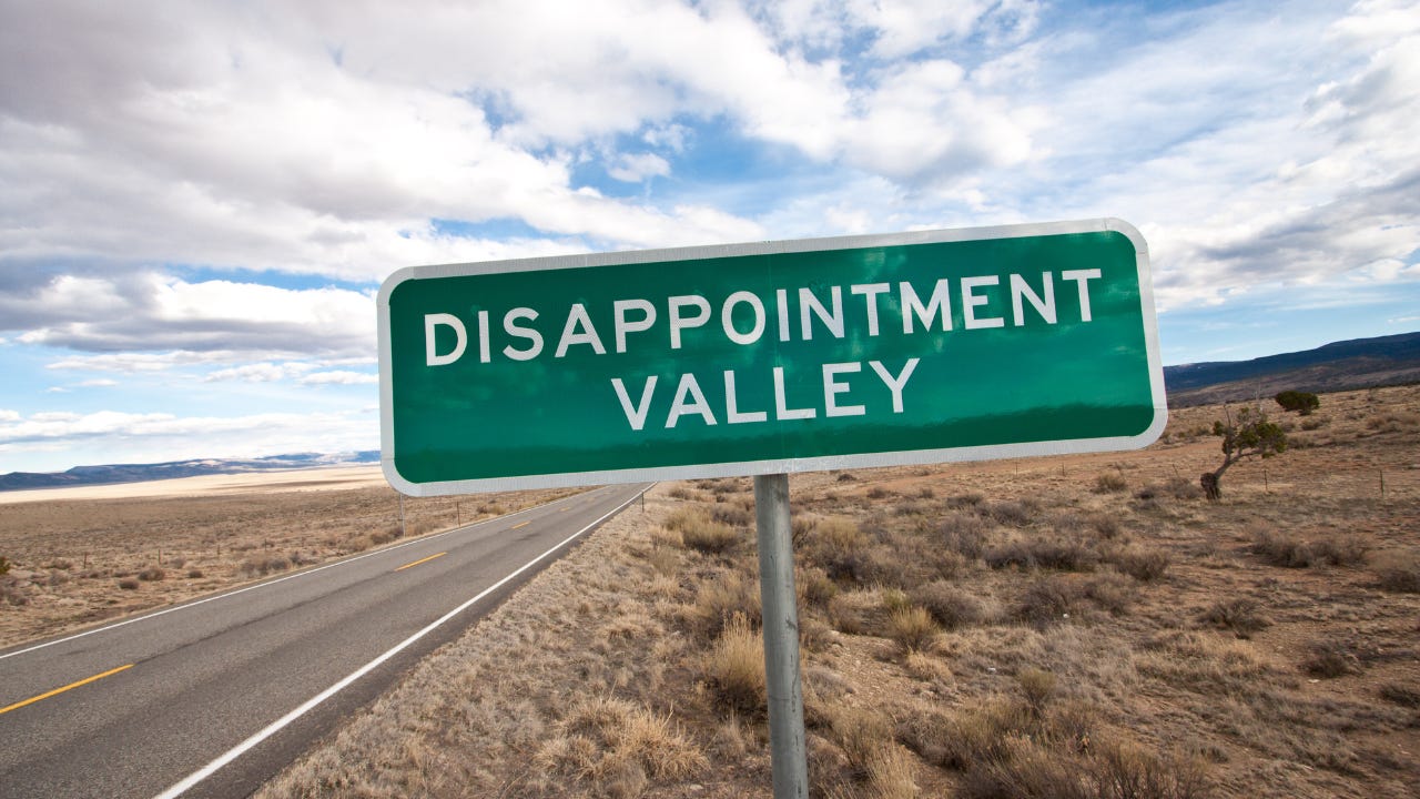 A road sign that says "Disappointment Valley."