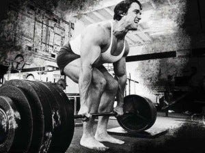 Arnold Schwarzenegger lifting weights barefoot