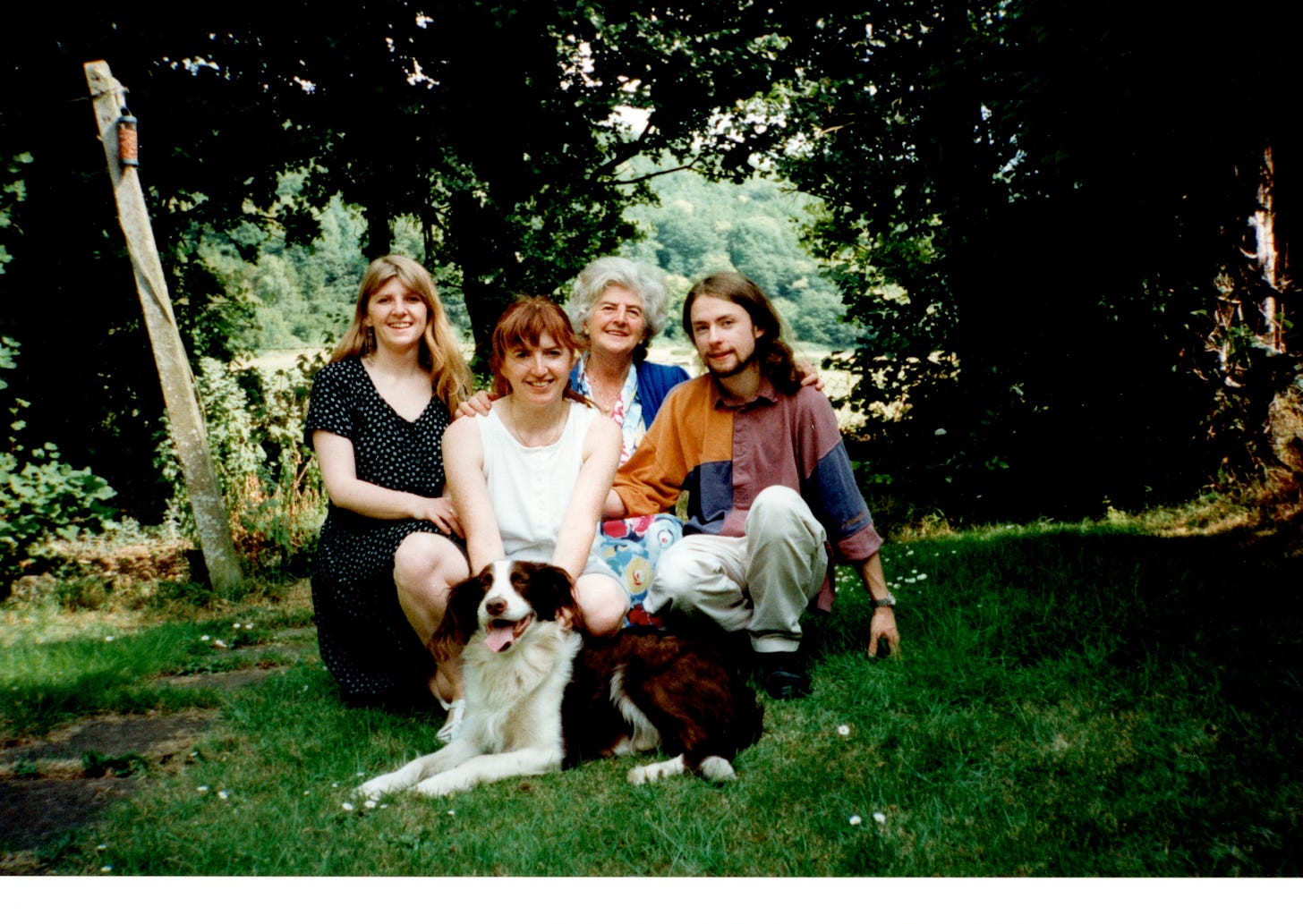 A family on the lawn with a hound