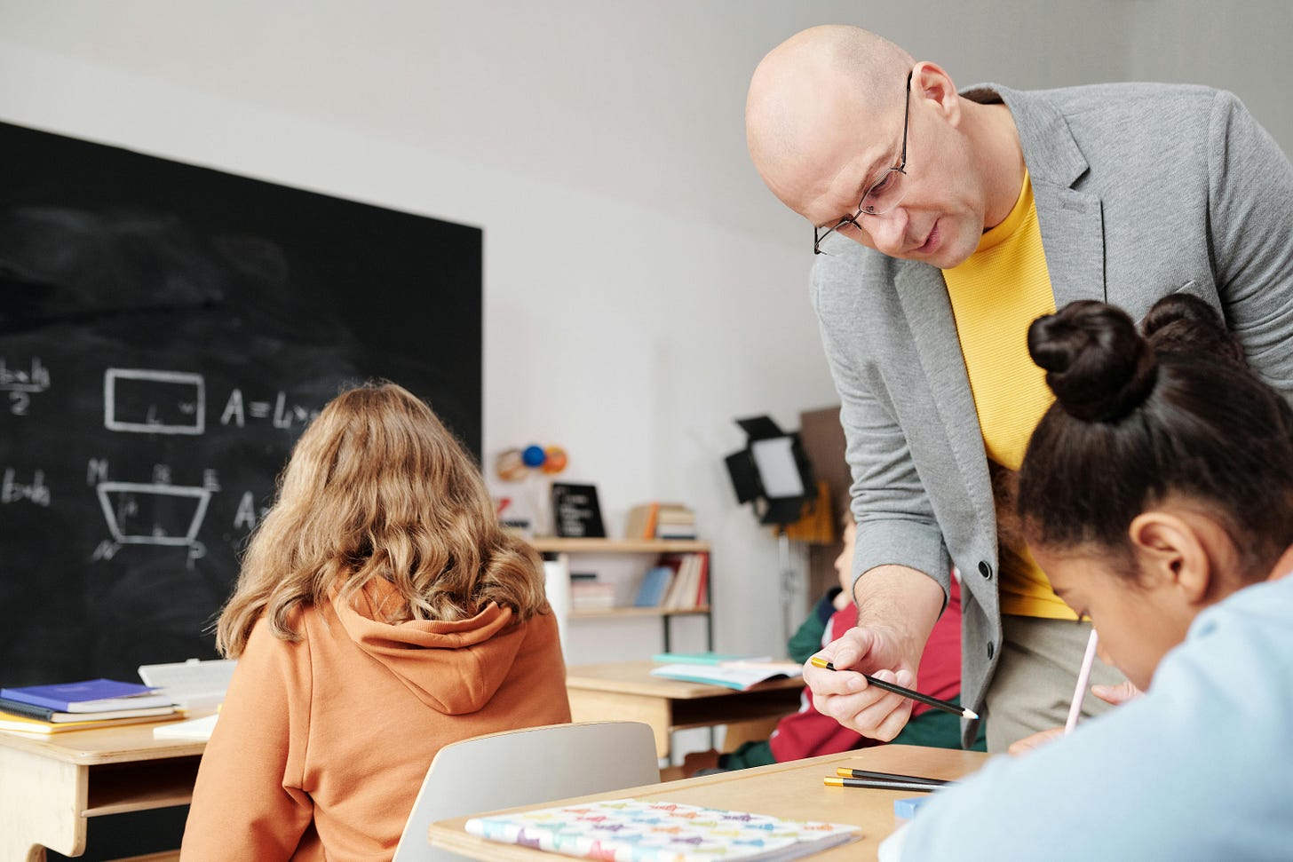Teacher in a classroom helping a student