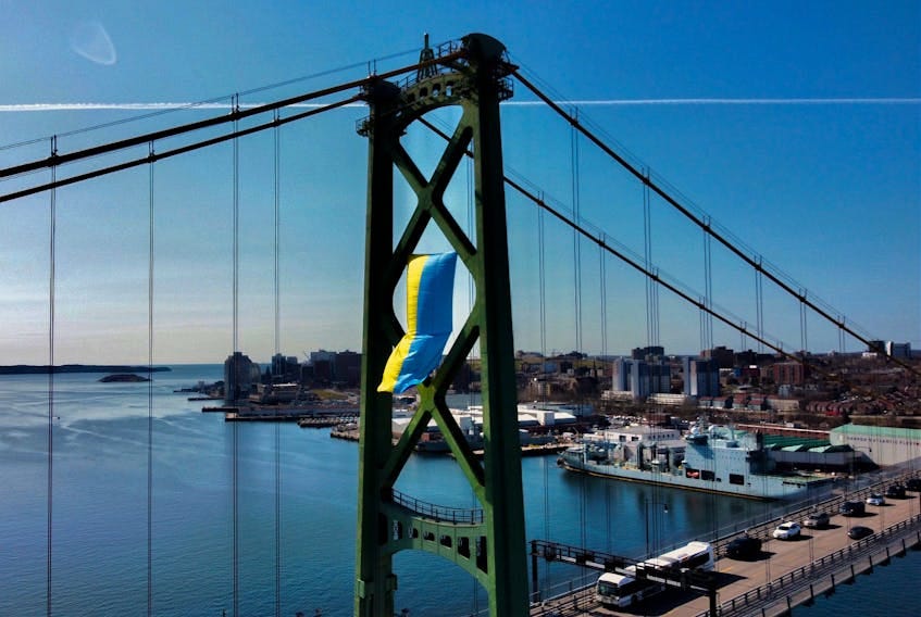 FOR NEWS STANDALONE:
A 20' x 40' Ukrainian flag i seen on a tower on the Angus Macdonald Bridge as a gesture of solidarity with Ukraine, in Dartmouth Thursday April 21, 2022. It is the first time the flag of another country has been displayed on the bridge. 

TIM KROCHAK PHOTO