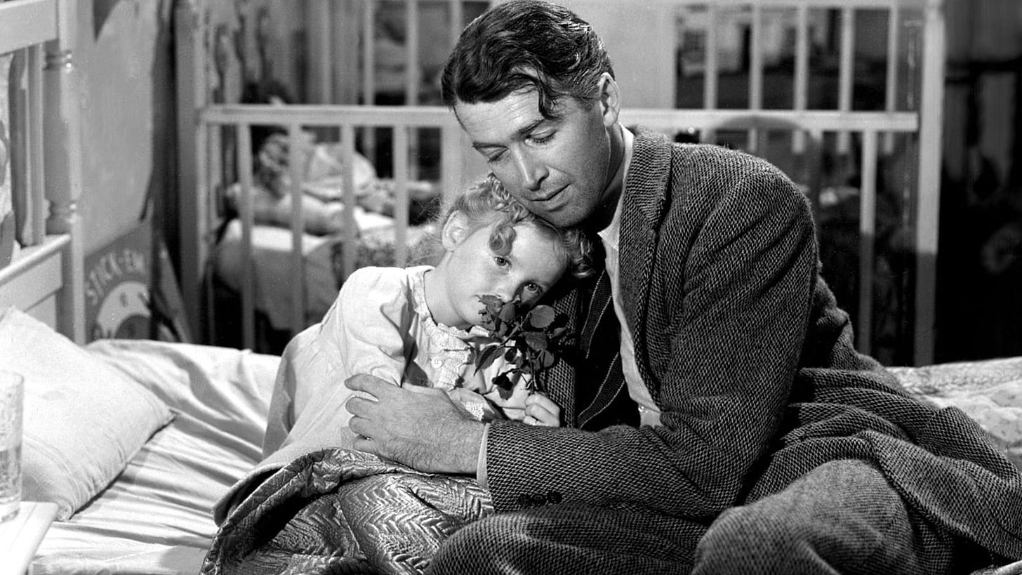 Zuzu (Karolyn Grimes) and George Bailey (James Stewart) in It’s a Wonderful Life