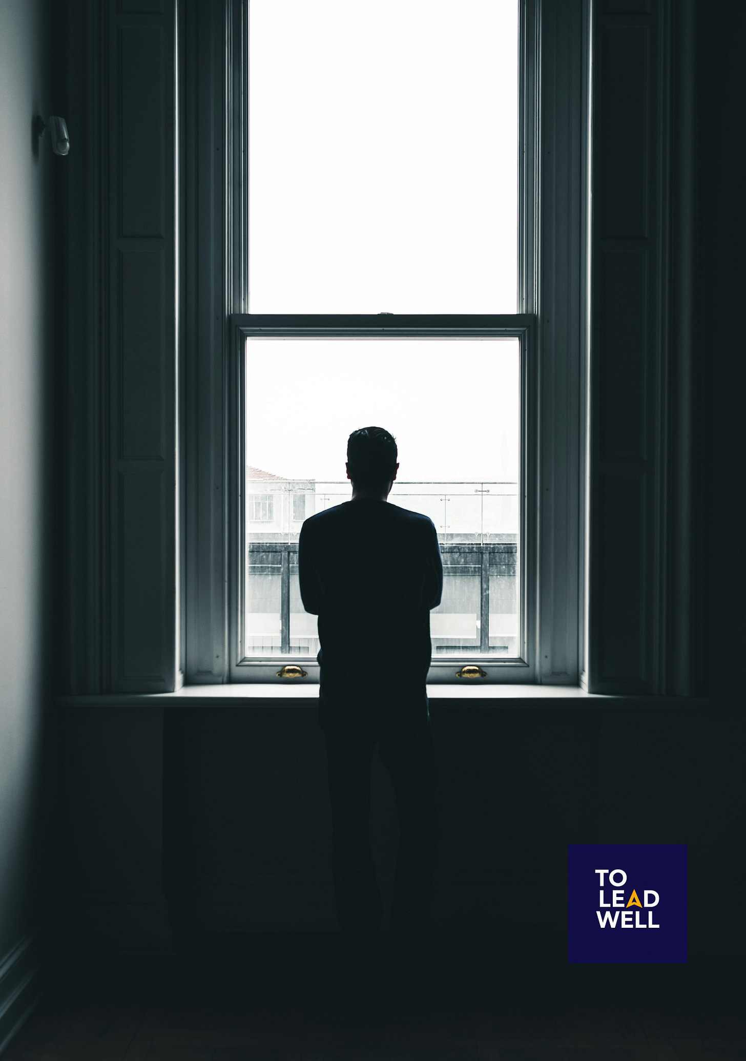 silhouette of person standing in front of window at daytime