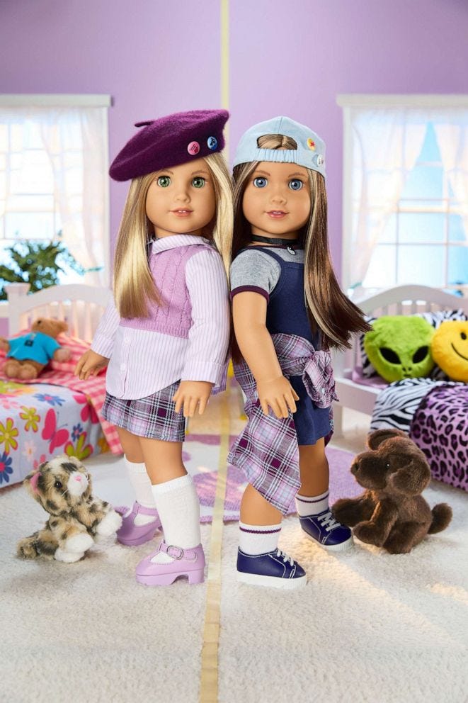 An image of the two new dolls, back to back, standing in their 90s themed bedroom.