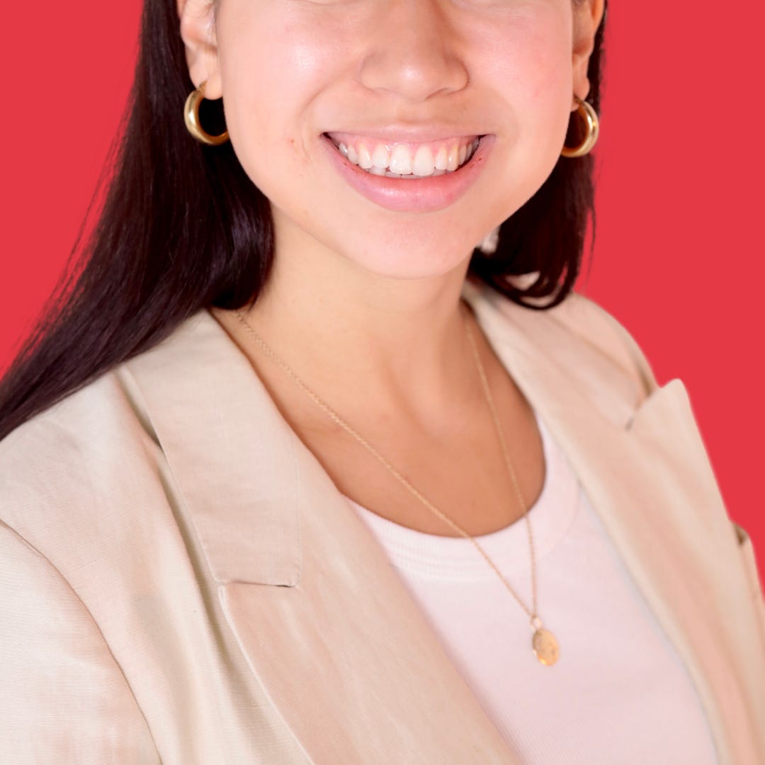 Author's professional headshot against a red background