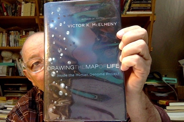 Some old bald guy peering from behind a copy of Victor McElhenny's "Drawing the Map of Life: Inside the Human Genome Project" Some old bald guy peering from behind a copy of Victor McElhenny's "Drawing the Map of Life: Inside the Human Genome Project"