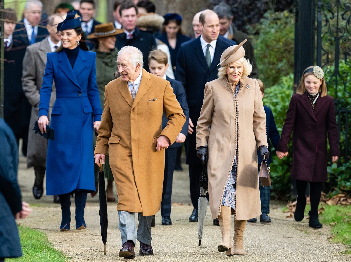 King Charles and Queen Camilla walking ahead of Prince William, Princess Kate and other senior royals