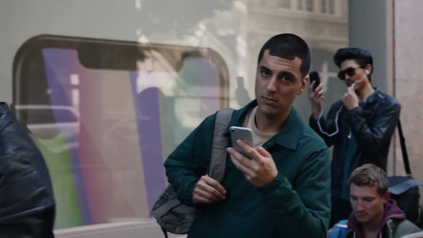 Person standing in line for an iPhone with an iPhone notch haircut