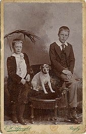 Childhood photograph of Rupert Brooke (right) with his younger brother Alfred Brooke (left) and dog Trim (1898)