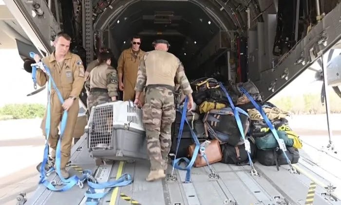 French Armed Forces personnel load belongings of evacuees onto a plane at the airport in Khartoum, Sudan, on April 23, 2023. (French Armed Forces via AP)
