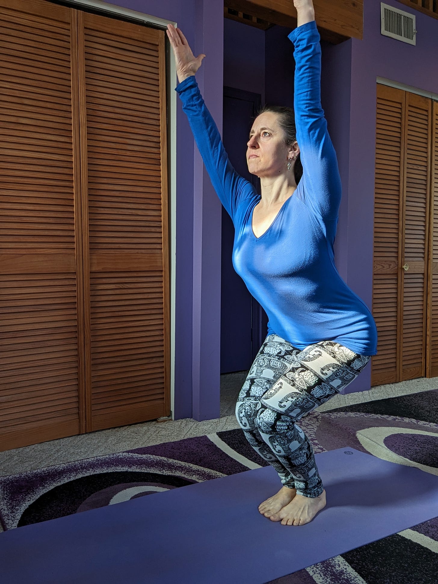 A demonstration of Utkatasana, or Awkward pose