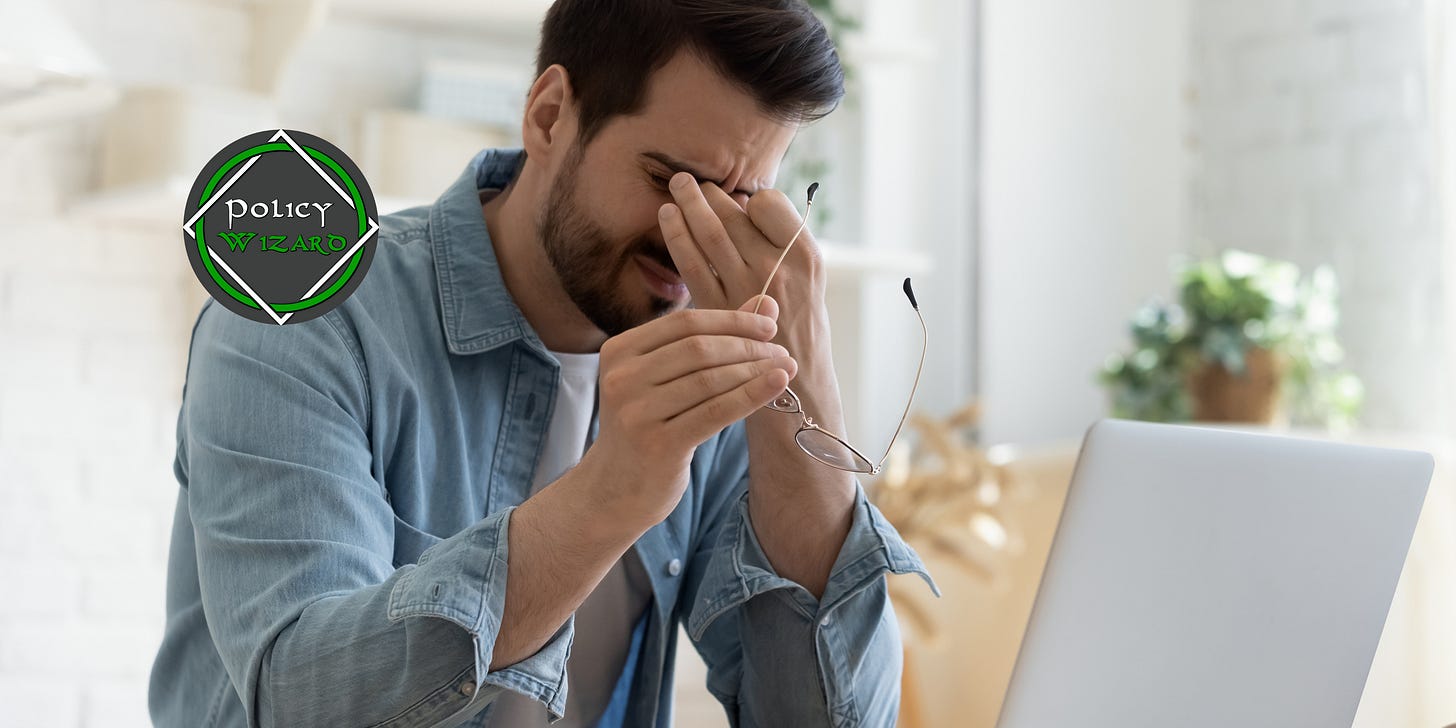Tired man with glasses holding eyes