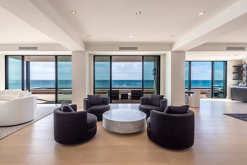 Floor-to-ceiling glass windows showcase the ocean views. Weller Photography