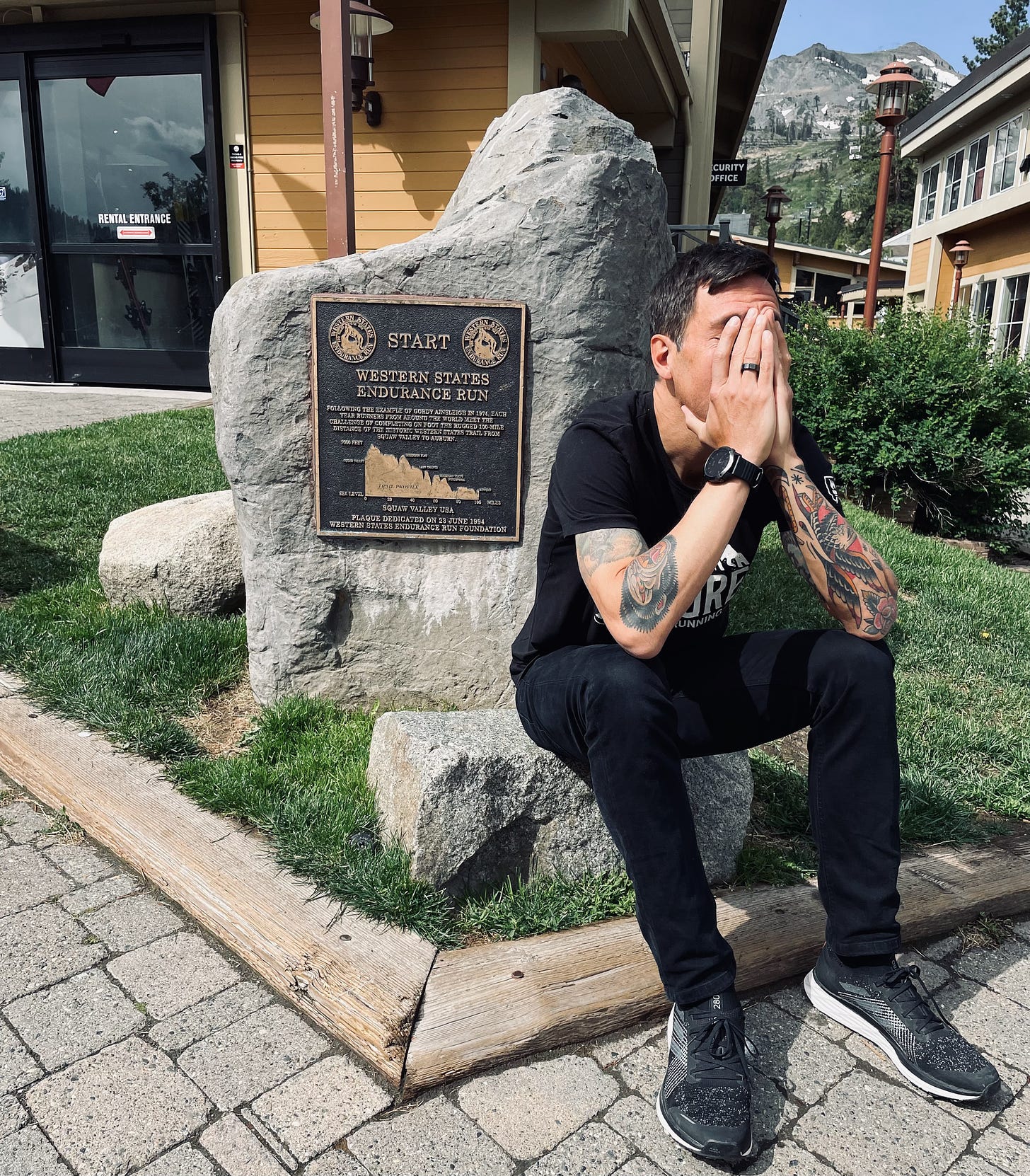 The author sitting in front of a western states memorial plaque being desperate