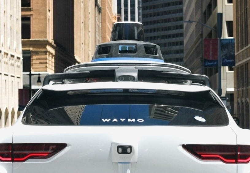 a car that is driving down the street