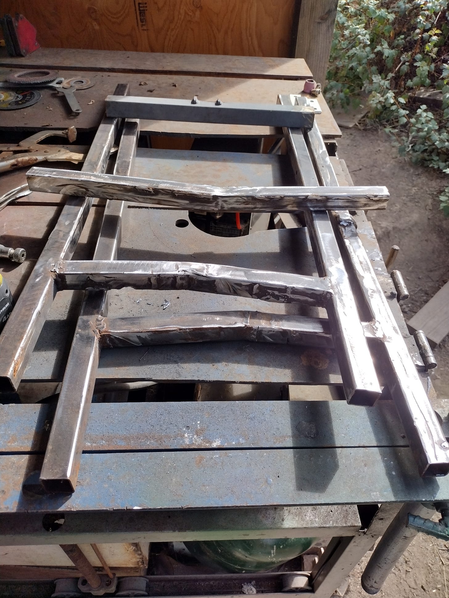 Metal pieces roughly piled in a ladder-ish shape.