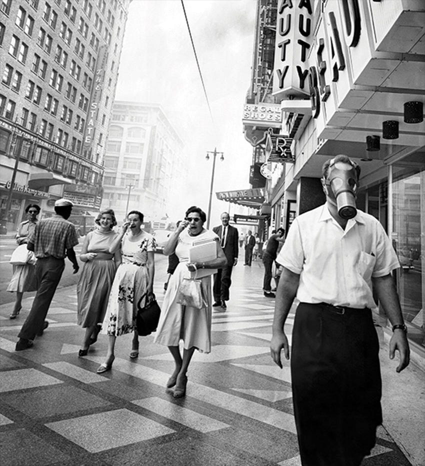 Man walking in 1940s Los Angeles wearing gas mask