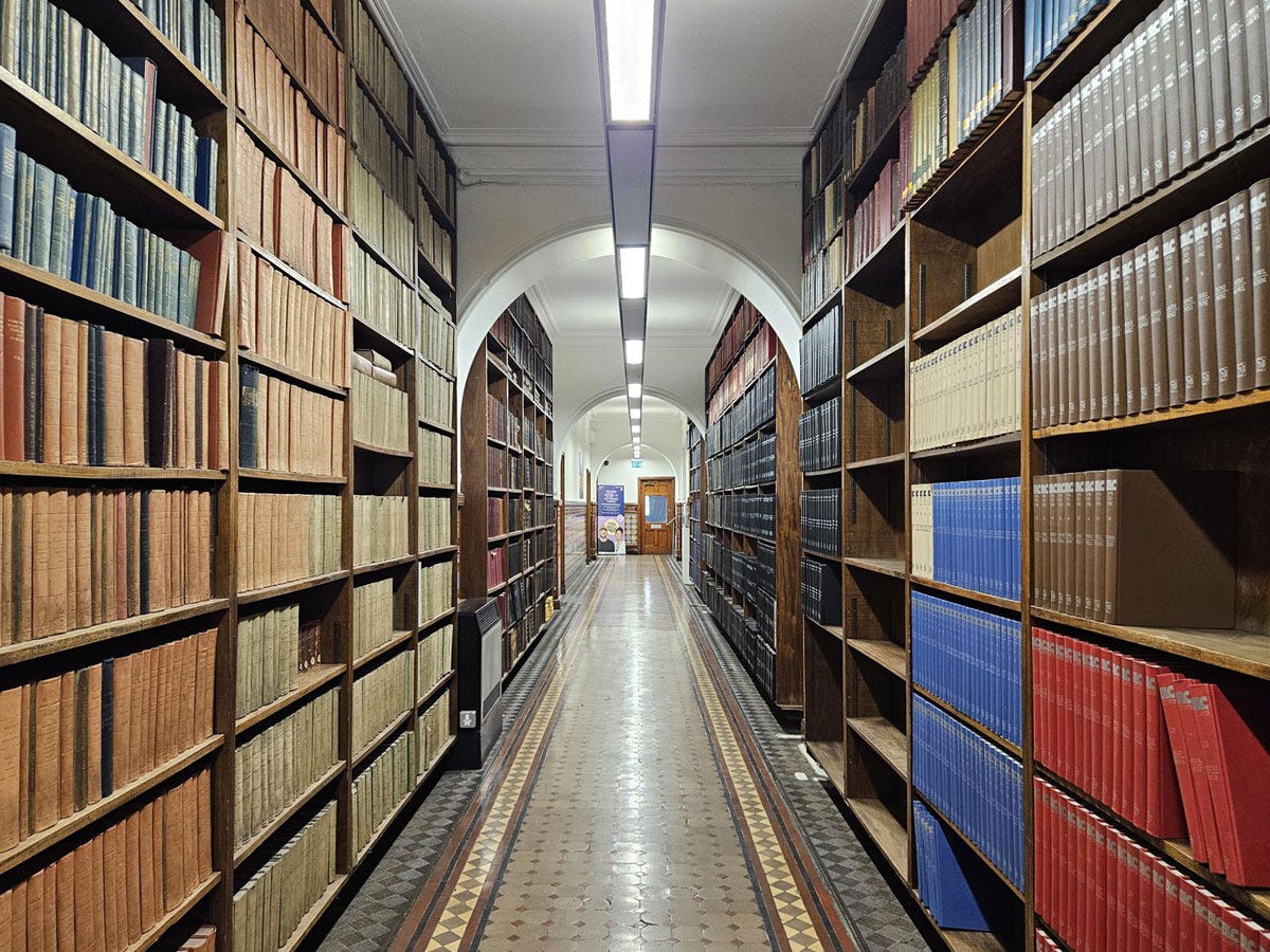 A corridor lined with book cases on each side