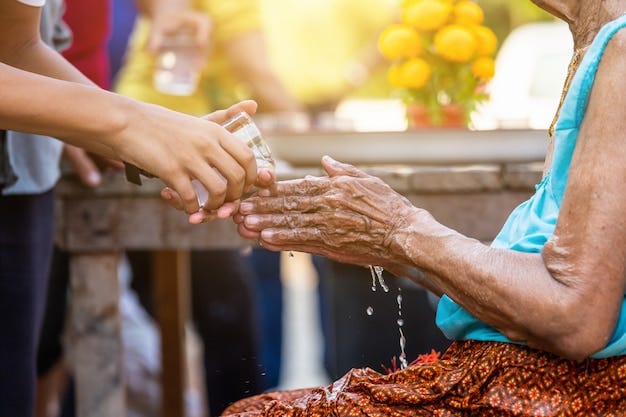 Premium Photo | Pouring water on the hands of revered elders and ask ...
