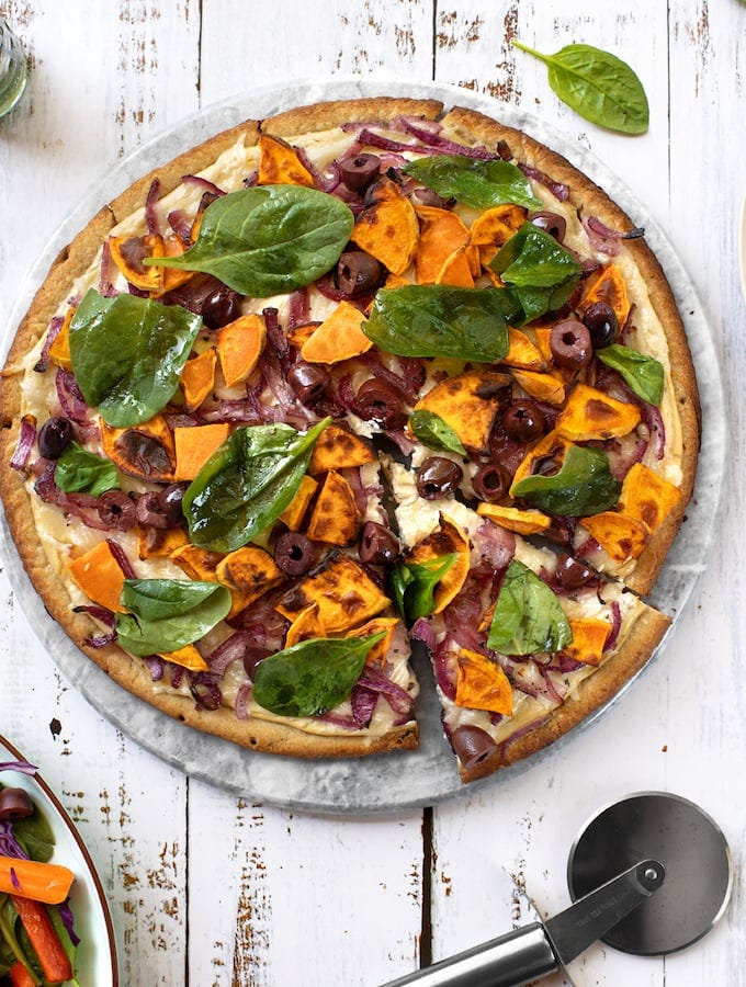 Vegan Sweet potato pizza with onions, olives, & spinach