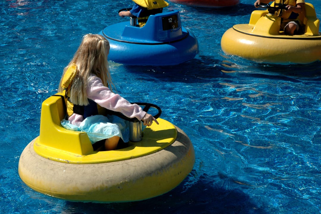 people on bumper boats in the water