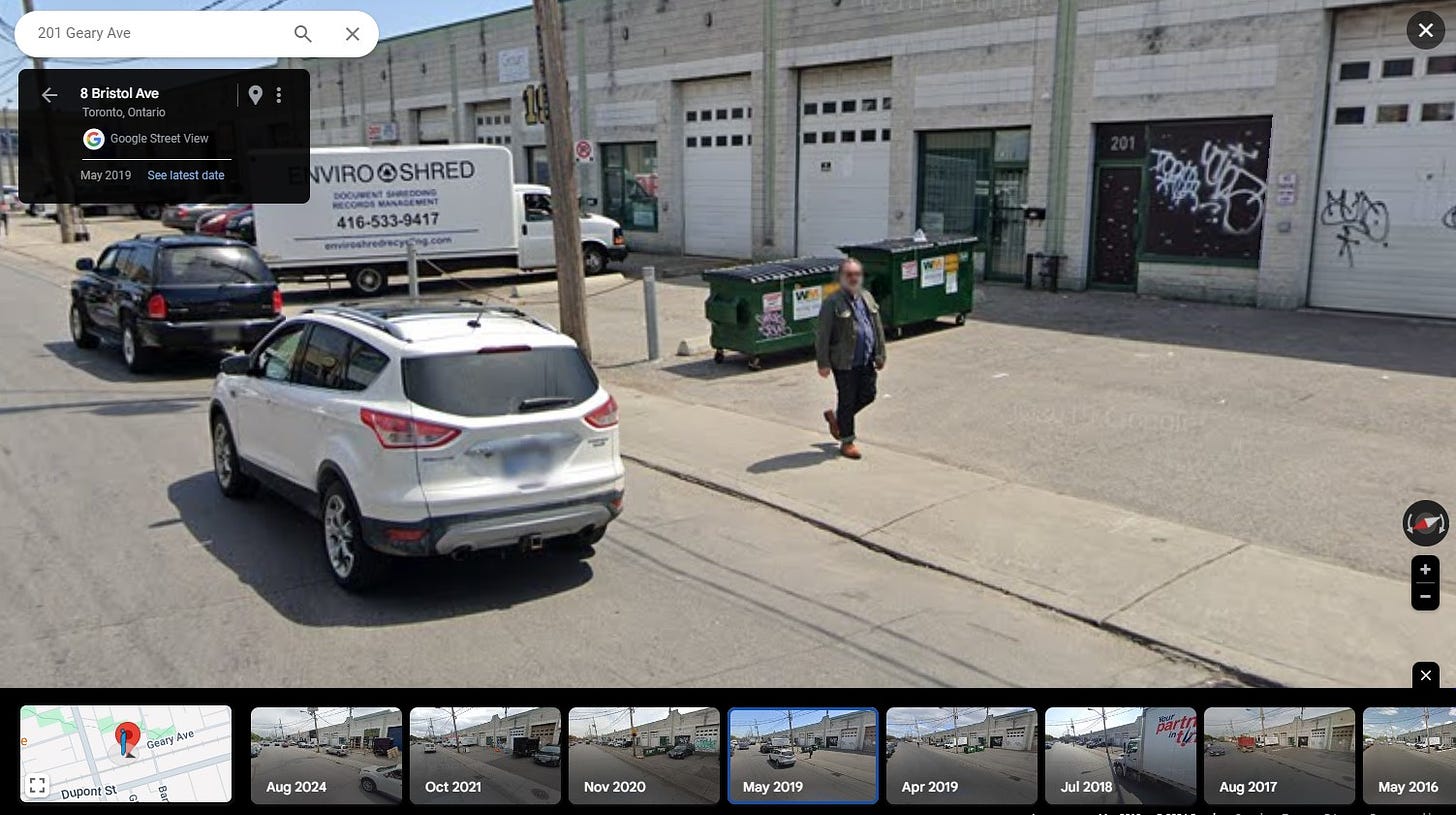 A screenshot of Google Street View having captured me, in a green jacket and jeans (and a shirt, of course), walking along the street. 