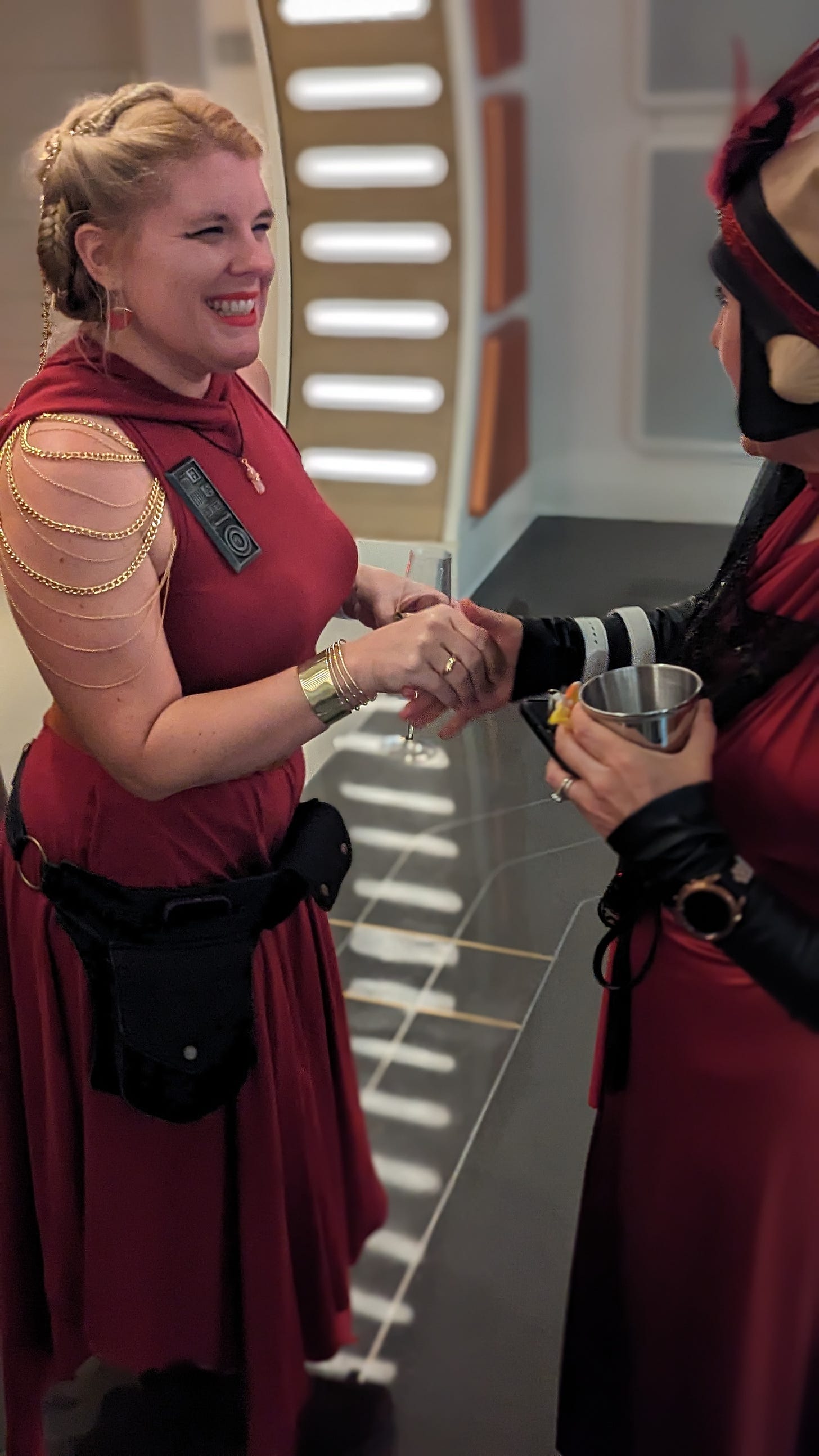 Cass smiling and greeting a Twi'lek passenger