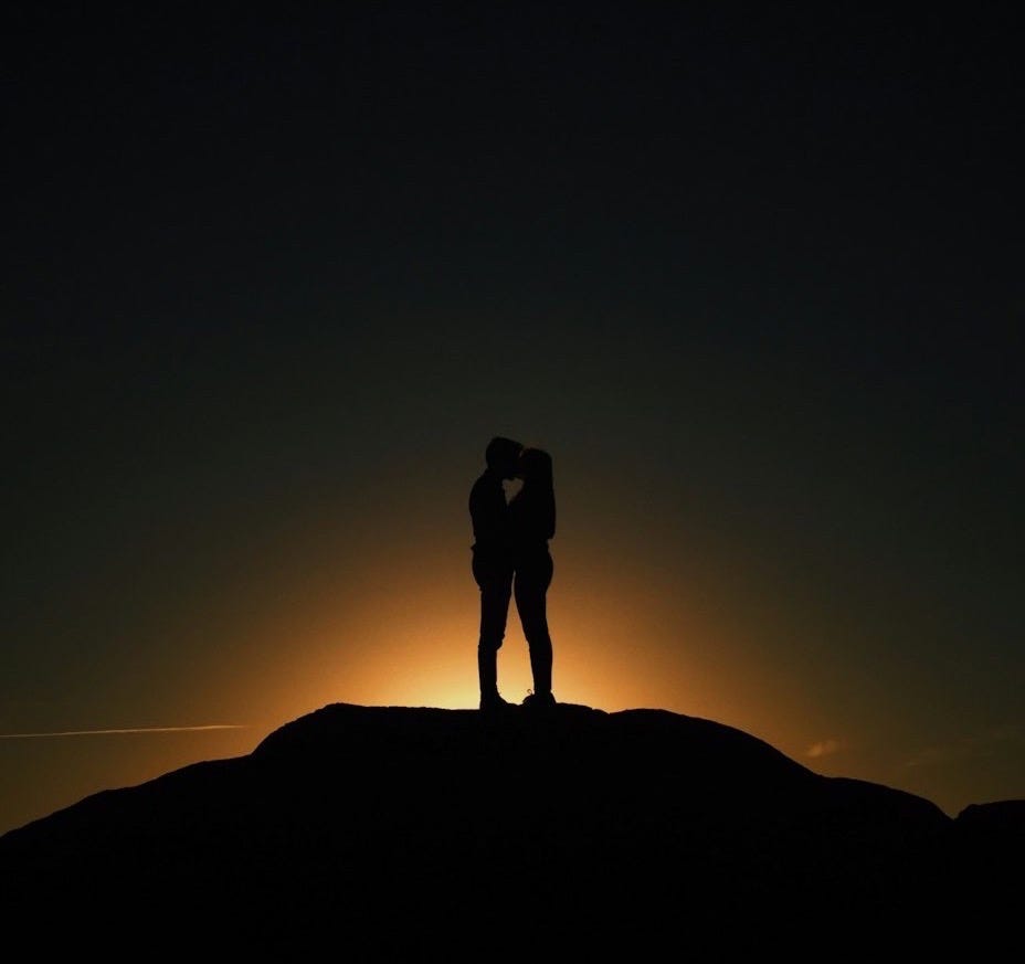 man and woman kissing