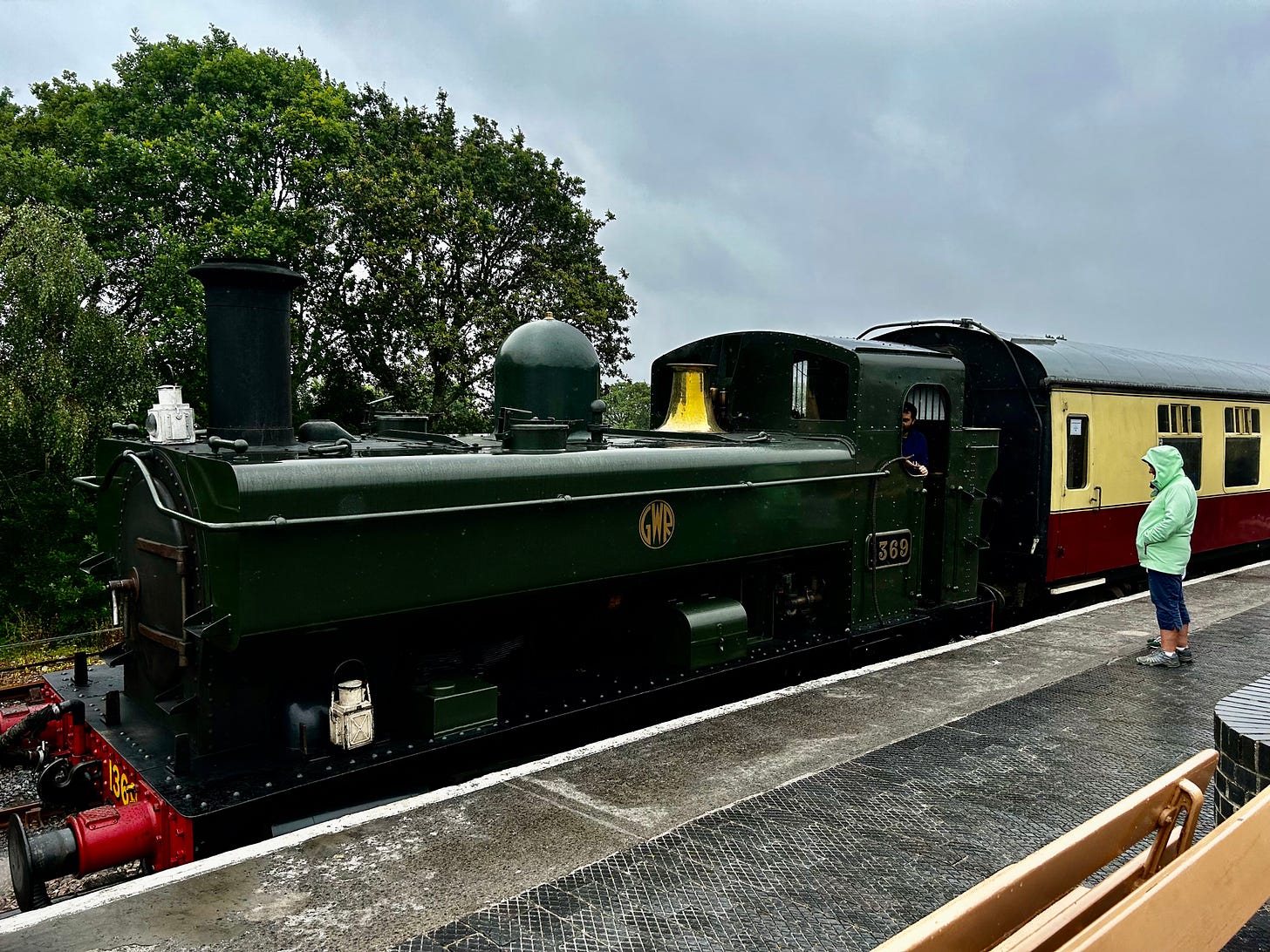 The GWR 0-6-0PT stands ready to leave Totnes Riverside Station. Her dark green paintwork dampened in the dismal weather. South Devon Railway runs several steam trains. Image: Roland's Travels