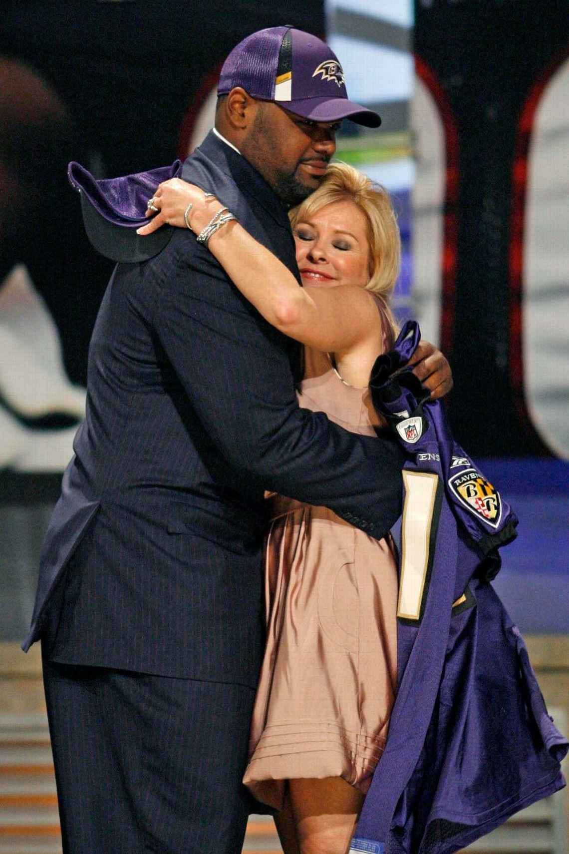 Michael Oher hugged by a woman cosplaying someone who cared for him