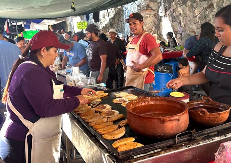 People serving food at a market