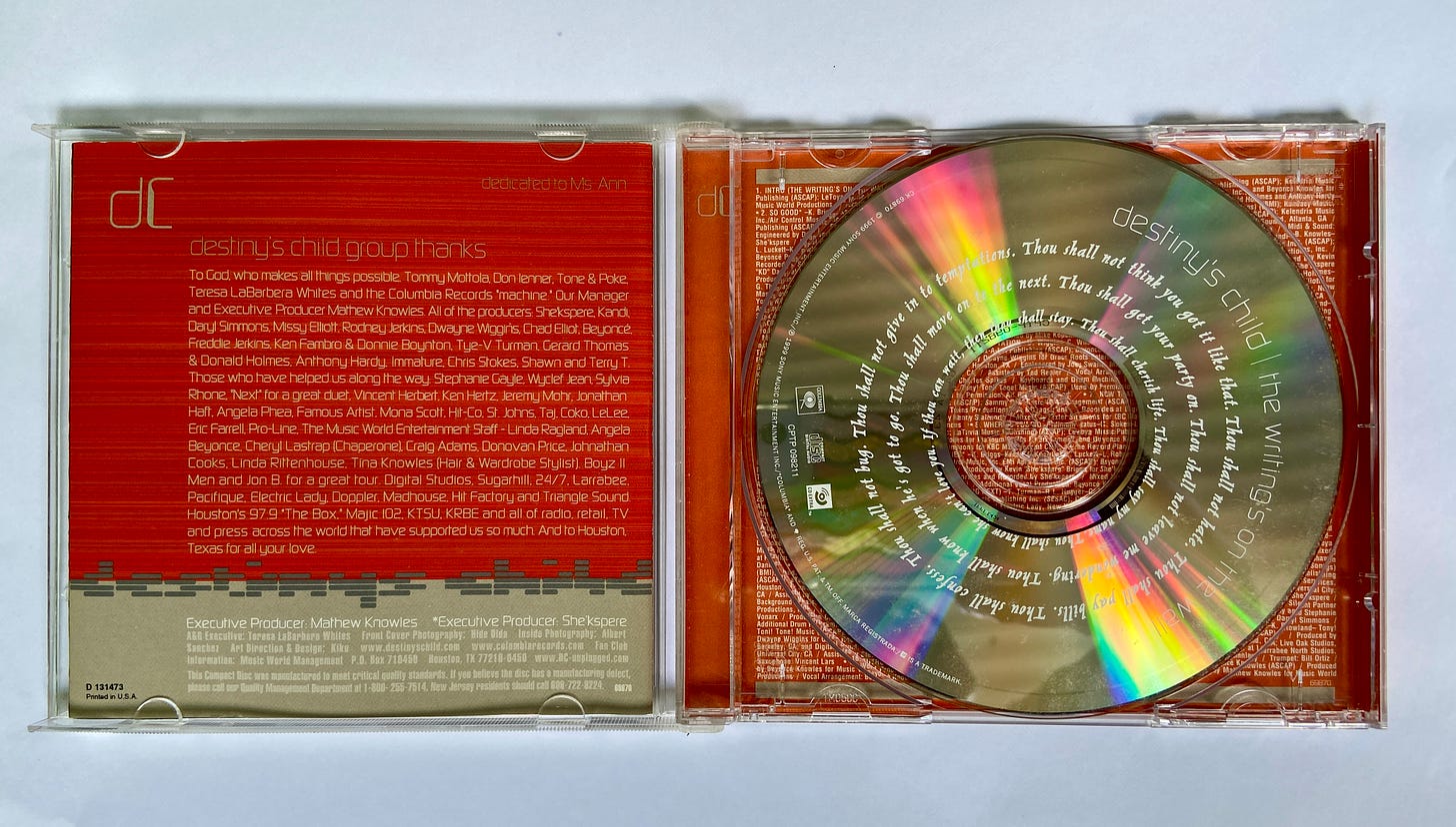 an open CD jewel case with the disc inside. there are thank yous from the group Destiny's Child printed on orange paper.